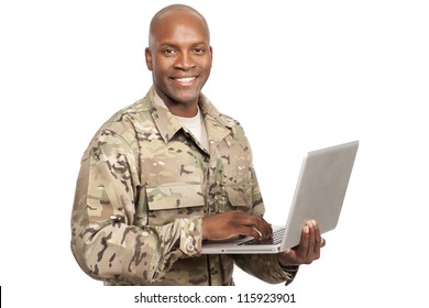 African American Soldier Smiles While Typing A Computer