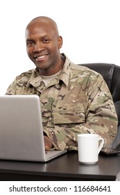 African American Soldier Smiles While Working On A Computer