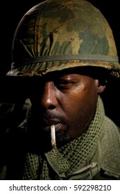African American Soldier (Vietnam War) Suffering With PTSD And Smoking A Cigarette.