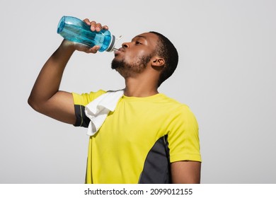 african american sportsman drinking water from sports bottle isolated on grey - Powered by Shutterstock