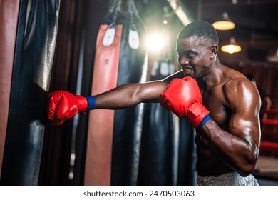 African American sportsman practicing and exercise in fitness stadium. Active fitness trainer or athlete bodybuilder male working out, training exercise to maintain muscle for health care at gym club. - Powered by Shutterstock