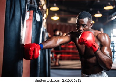 African American sportsman practicing and exercise in fitness stadium. Active fitness trainer or athlete bodybuilder male working out, training exercise to maintain muscle for health care at gym club. - Powered by Shutterstock