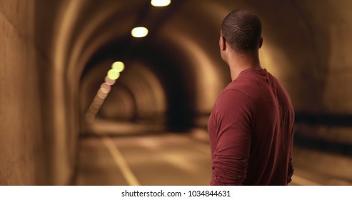 African American stares down a tunnel
