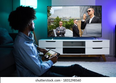 African American Streaming And Watching Movie On TV Screen