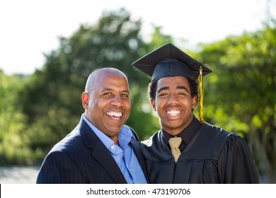 African American Student Celebrating Graduation With His Dad.