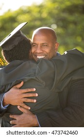 African American Student Celebrating Graduation With His Dad.