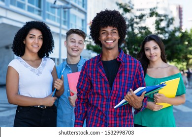 African American Student With Group Of Latin And Hispanic And Caucasian Students Outdoor In The Summer In The City