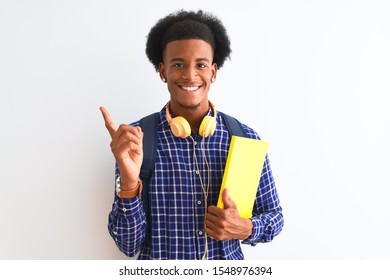 African American Student Man Wearing Headphones Backpack Over Isolated White Background Very Happy Pointing With Hand And Finger To The Side