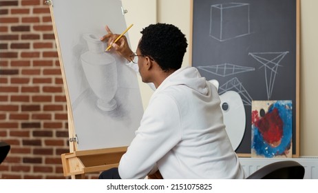 African American Student Using Pencil To Draw Vase On Canvas, Learning Creative Skills At Drawing School Lesson. Artwork Creation Using Practice Tools And Instruments For Personal Development.