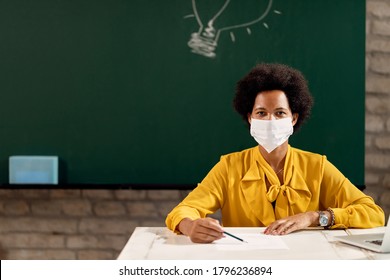 African American Teacher With Protective Face Mask Holding A Class At The School. Copy Space.