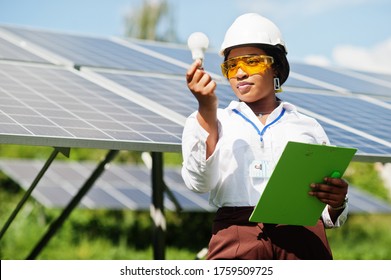 African american technician check the maintenance of the solar panels. Black woman engineer at solar station. - Powered by Shutterstock