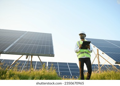 African american technician check the maintenance of the solar panels. Black man engineer at solar station - Powered by Shutterstock