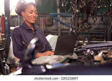 African american technician female Mechanic working under the hood at the repair garage. - Powered by Shutterstock