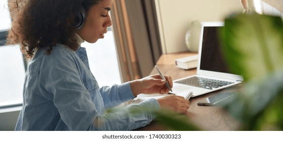 African American Teen Girl Student Pupil Wear Headphones Distance Learning Studying Online At Home Office Making Notes Listening Web Course. Remote College School Education, Elearning Concept. Banner