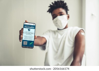 African American Teenager Shows Vaccine Passport On Mobile Phone To Validate Travel Permission By The Digital Document