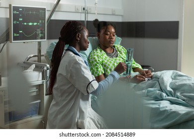 African American Therapist Doctor Standing Beside Sick Patient During Medical Appointment Explaining Bones Radiography Expertise In Hospital Ward. Physician Woman Discussing Healthcare Expertise