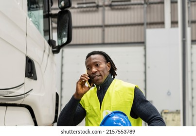 African American Truck Driver Talking On The Phone And Having An Argument In Front Of The Truck Trailer. Truck Transportation Problems. Trouble On The Way.