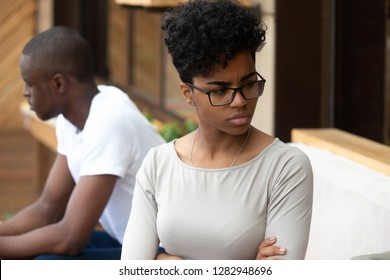 African american unhappy couple sitting on sofa after quarrel fight thinking about break up or divorce. Frustrated black upset female and male not talking having conflict. Bad relationships concept