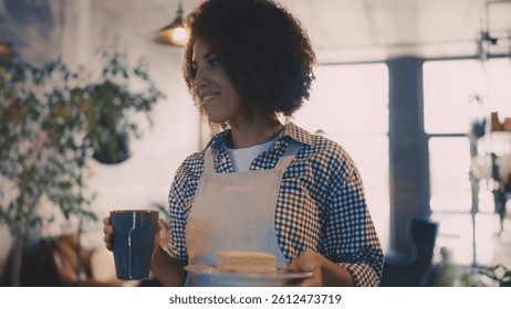 African American waitress serving coffee and dessert to customer in cafeteria