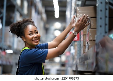 African American warehouse worker take flat box from shelf in big warehouse factory, Online shopping store for logistic service to deliver the shipment, check barcode before passing to transportation - Powered by Shutterstock