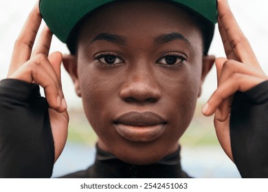 african american woman adjusting her cap - Powered by Shutterstock