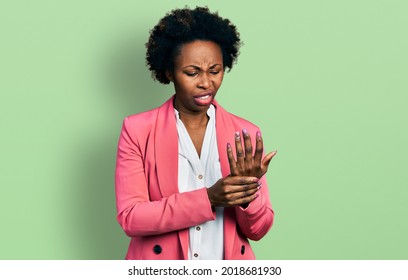 African American Woman With Afro Hair Wearing Business Jacket Suffering Pain On Hands And Fingers, Arthritis Inflammation 