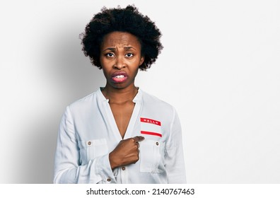 African American Woman With Afro Hair Wearing Hello My Name Is Sticker Identification Clueless And Confused Expression. Doubt Concept. 
