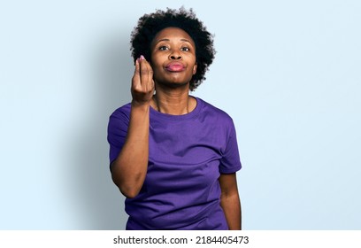 African American Woman With Afro Hair Wearing Casual Purple T Shirt Doing Italian Gesture With Hand And Fingers Confident Expression 