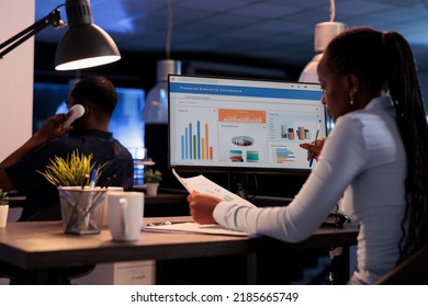 African american woman analyzing business charts on computer and documents, looking at online research data to create presentation. Working with information on report, statistics on pc. - Powered by Shutterstock