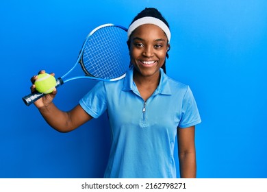 African american woman with braided hair playing tennis holding racket and ball looking positive and happy standing and smiling with a confident smile showing teeth  - Powered by Shutterstock