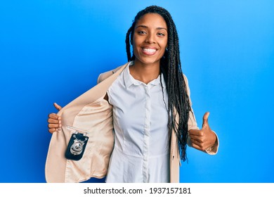 African American Woman With Braids Showing Detective Badge Smiling Happy And Positive, Thumb Up Doing Excellent And Approval Sign 