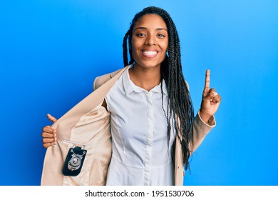 African American Woman With Braids Showing Detective Badge Smiling With An Idea Or Question Pointing Finger With Happy Face, Number One 