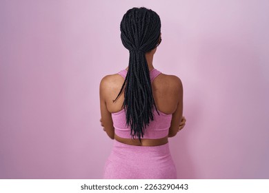 African american woman with braids wearing sportswear over pink background standing backwards looking away with crossed arms  - Powered by Shutterstock