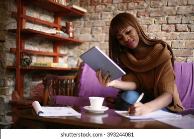 African American Woman Calculating Her Bills. 