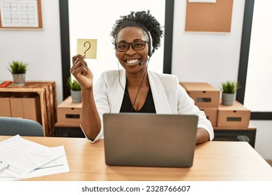 African american woman call center agent smiling confident holding question mark reminder paper at office - Powered by Shutterstock