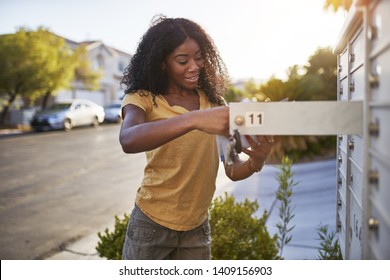 african american woman checking mail in las vegas community             