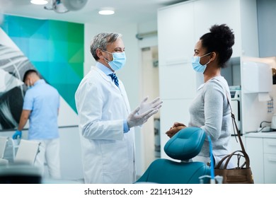 African American Woman Communicating With Her Dentist After Dental Procedure During Coronavirus Pandemic.