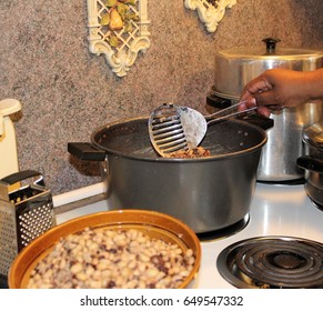 African American Woman Cooking Peas On The Stove