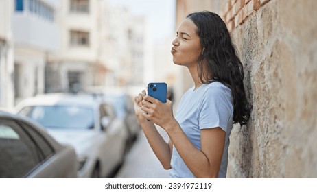 African american woman dancing listening to music on smartphone doing drummer gesture at street - Powered by Shutterstock