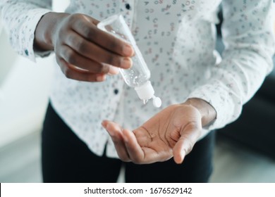 African American Woman Disinfecting Skin With Hand Sanitizer