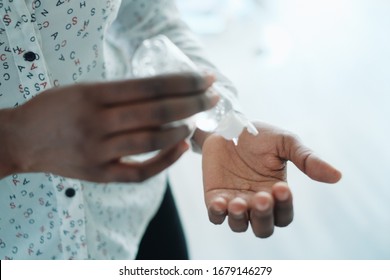 African American Woman Disinfecting Skin With Hand Sanitizer - Powered by Shutterstock