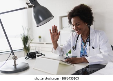 African American Woman Doctor Working At Her Office Online Using Portable Inormation Device. Telemedicine Services. Primary Care Consultations, Psychotherapy, Emergency Services. 