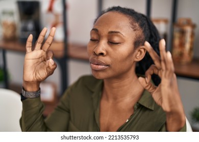 African American Woman Doing Yoga Exercise Sitting On Chair At Home