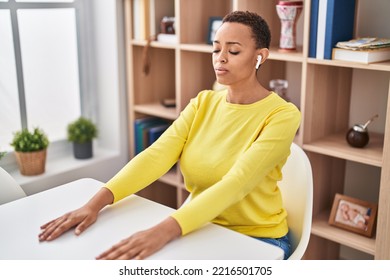 African American Woman Doing Yoga Exercise Sitting On Table At Home