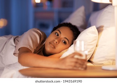 African American Woman Drinking Water At Night