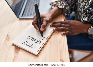 African american woman ecommerce business worker using laptop writing on notebook at office - Powered by Shutterstock