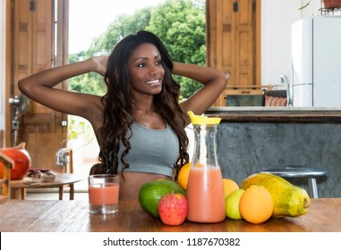 African American Woman Enjoys Fruits And Healthy Drinks After Sports