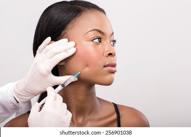 African American Woman Face Lifting On Her Cheek