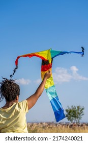 African American Woman Flying A Colorful Kite 
