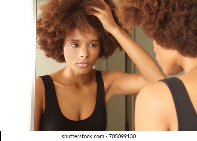 African American Woman Getting Ready For Work In The Mirror